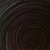 SmugMug > keywords > polaris > Neat star trail from Dec 18 2009, Leics, UK. Extremely cold (-6C) yet clear skies, ideal for startrail work. I focused on polaris and increased the focal length to work the close up effect. Taken with Olympus E3, 12-62mm SWD. Camera left out from 2100hrs on Dec 17th through 0700hrs  Dec 19th capturing exposure every 15s for the entire period. Photo composite put together with startrails.de software. Annoying plane trails bottom right. Tripod and camera were frozen solid the following morning. Camera still firing away mind! Can't beat Olympus gear for extreme work :)