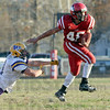 SmugMug > all-time keyword > andre > Escape: Marshall's #46, Andre Strohm fends off a tackler to gain some yardage during game action Saturday.