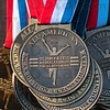 SmugMug > keywords > medals > For the top 40: Medals hang on the awards stand waiting to placed around the necks of the top 40 finishers in the men's and women's races of the NCAA Div. I Championships Monday at the LaVern Gibson Championship Cross Country Course.
