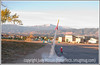 SmugMug > all-time keyword > launched > As the sun rises and hits Pike's Peak, a hobbyist rocket is launched from its pad in a school parking lot.