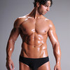 SmugMug > all-time keyword > briefs > Muscular young man standing bare chested in black brief style underwear