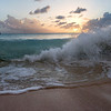 SmugMug > keywords > anchored > A wave breaks on 11 Mile Beach on Barbuda's west coast. A cruising sailboat is anchored off shore.