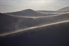 SmugMug > keywords > distance > Wind blows sand across backlit dunes in the Great Sand Dunes National Park, Colorado.