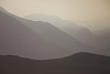 SmugMug > keywords > distance > Mountains glow in the evening haze of a wildfire in the Umatilla National Forest region of Eastern Oregon.